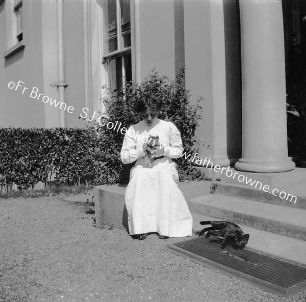 NELL BROWNE WITH CATS AT HALL DOOR OF BISHOP'S HOUSE